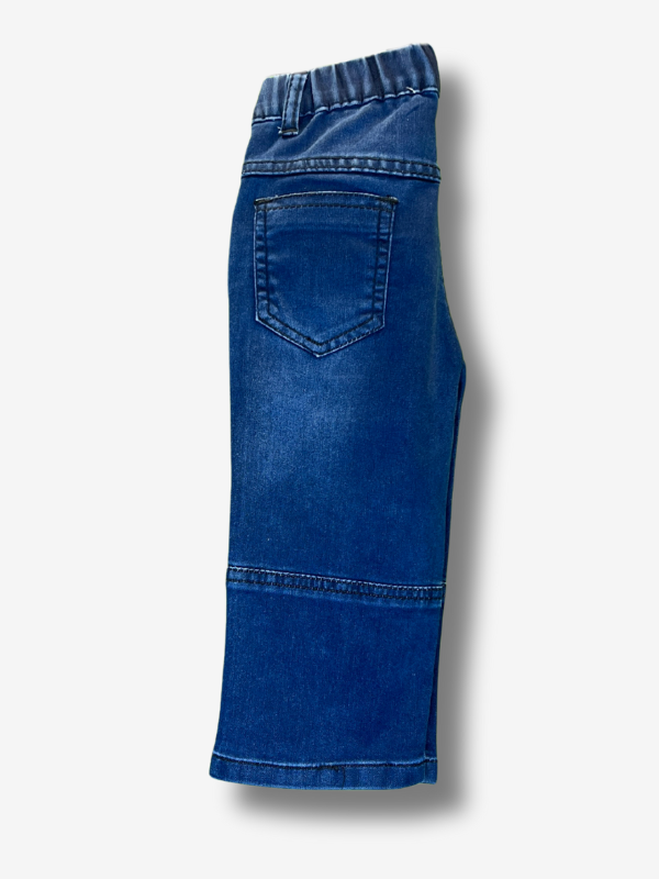 Boys' dark blue wash wide-leg denim jeans with a gathered elastic waistband and a colorful rainbow smiley face patch on the left side.
Export to Sheets