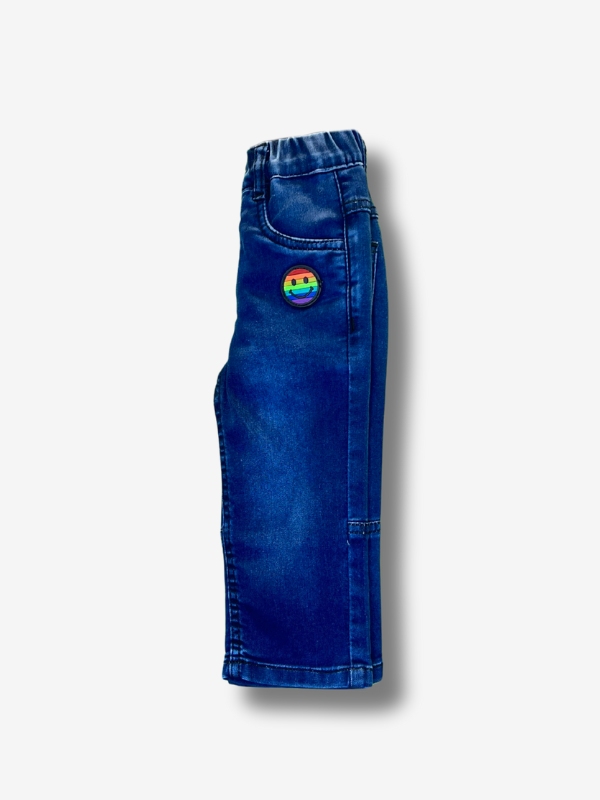 Boys' dark blue wash wide-leg denim jeans with a gathered elastic waistband and a colorful rainbow smiley face patch on the left side.
Export to Sheets