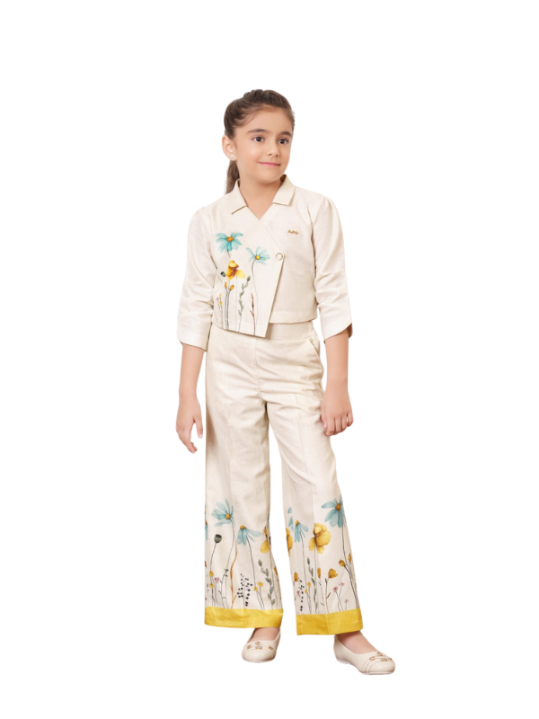 Young girl wearing a cream/off-white Indo-Western coordinate set consisting of a cropped three-quarter sleeve top and wide-leg palazzo pants, both featuring hand-painted yellow and blue floral designs