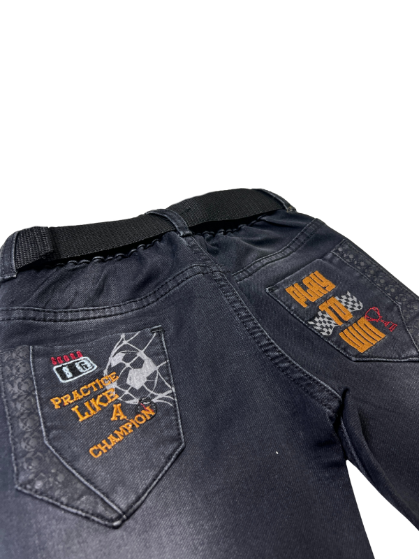 Boys' dark grey wash straight-leg jeans with white and orange graphic text on the leg, an elastic waist, and a wide black web belt with a black buckle.
Export to Sheets