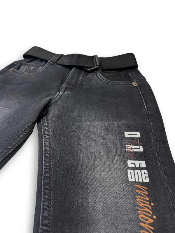 Boys' plain black denim jeans in a straight-leg style, featuring a gathered elastic waistband and a black web belt with a gold rectangular buckle.
Export to Sheets