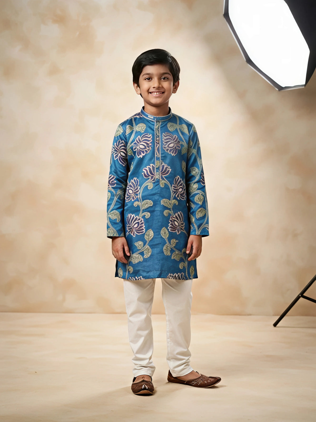 Boys wearing a blue floral printed full sleeve kurta with off-white trousers
