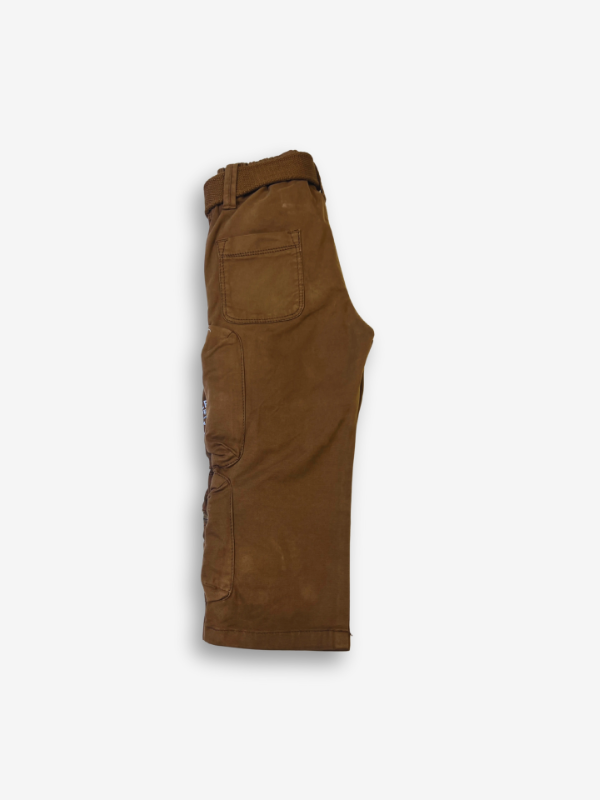 Boys' rustic brown cargo pants with many zippered side pockets, a matching web belt, and cuffed or slightly cropped leg openings.
Export to Sheets