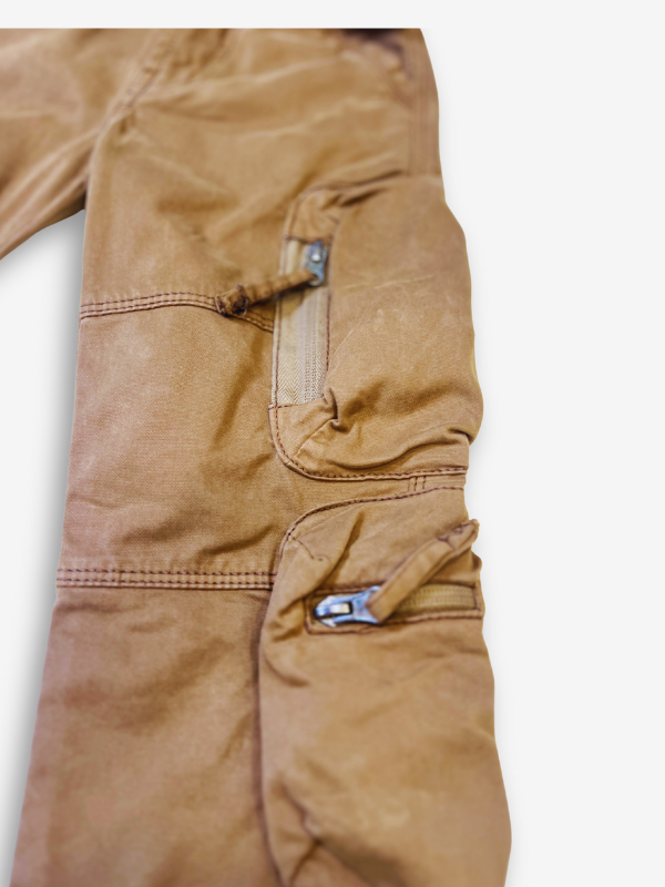 Boys' rustic brown cargo pants with many zippered side pockets, a matching web belt, and cuffed or slightly cropped leg openings.
Export to Sheets