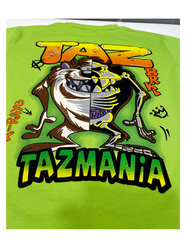 Bright Lime Green boys' short-sleeve T-shirt with a brown, white, and black distressed "TAZ MANIA" logo graphic printed centrally.