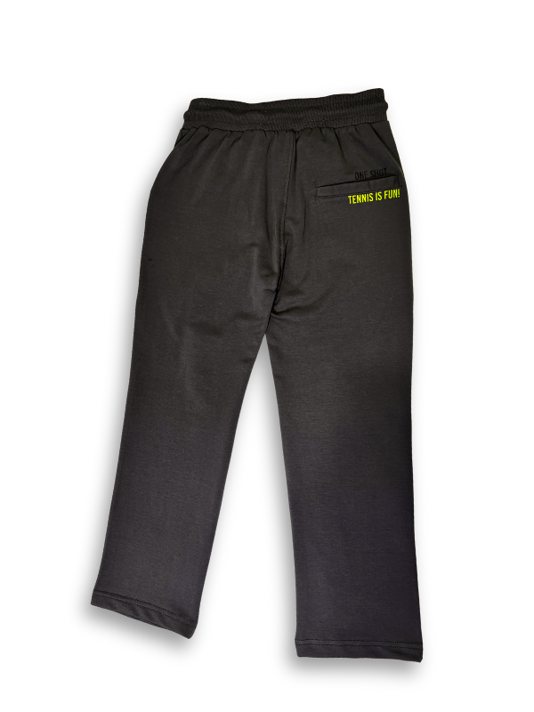 Boys' dark charcoal grey knit or fleece track pants with an elastic waist, pockets, and neon yellow "TENNIS" and tennis ball graphics on the legs.
Export to Sheets