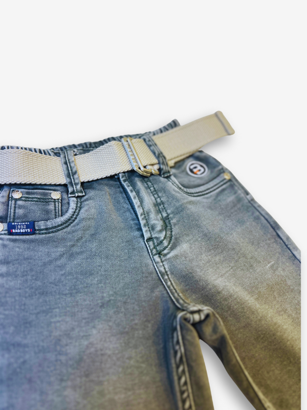 Boys' olive green track pants or joggers with an elastic waist, straight leg, and a thick tan or cream-colored web belt with a silver buckle.
Export to Sheets