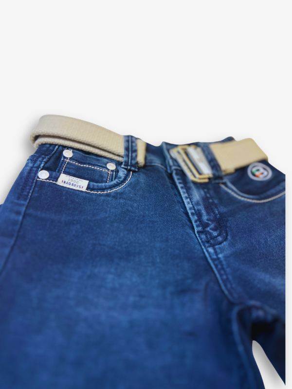 Boys' dark blue denim jeans with a straight fit, subtle fading, and a prominent tan or cream-colored web belt with a silver buckle.
Export to Sheets