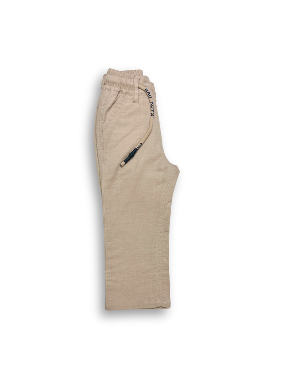 Boys' cream or pale khaki casual trousers with a comfortable elastic waistband, straight leg, and a thick, multicolored contrast rope drawstring.