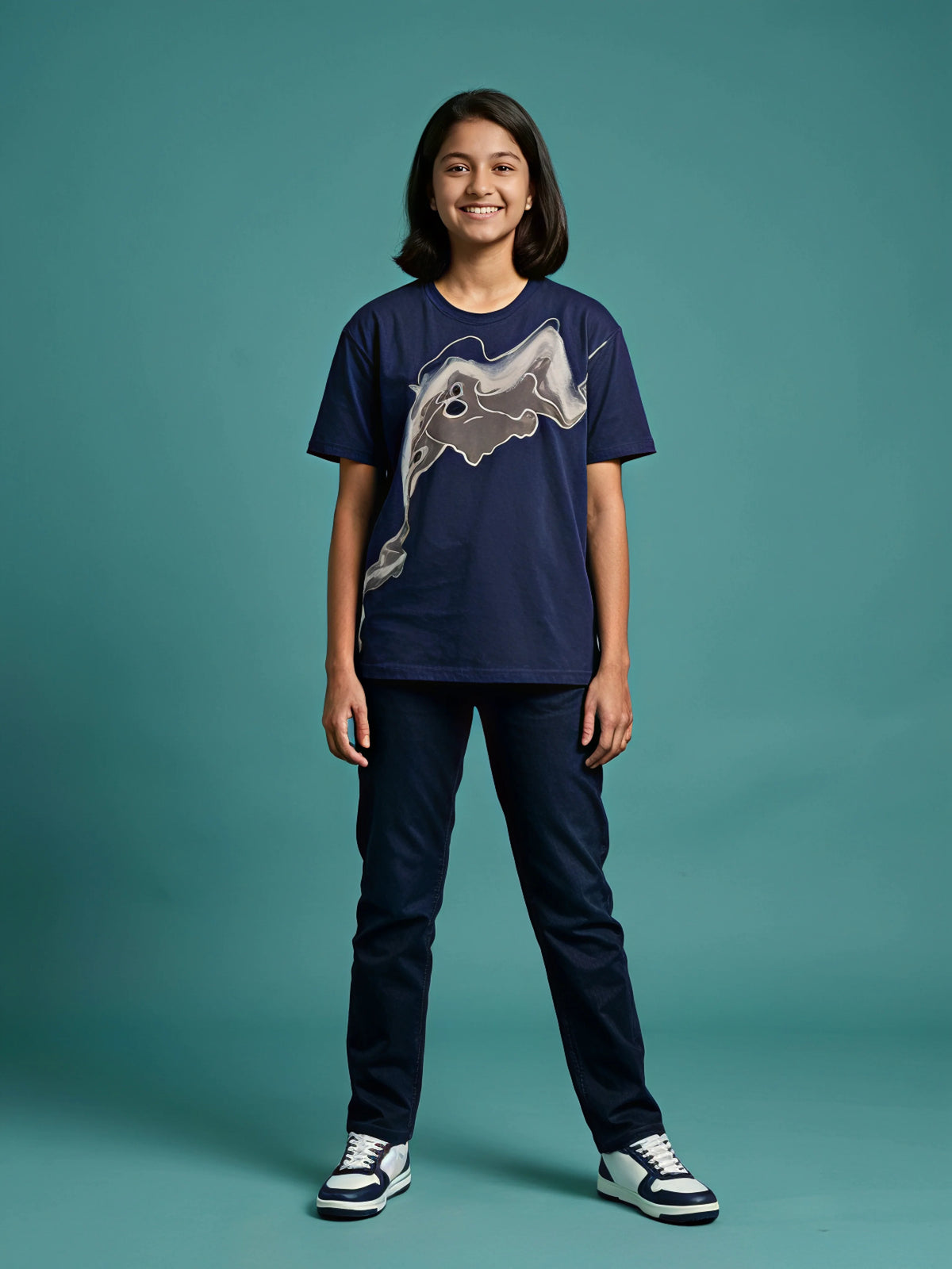 Girl wearing a navy blue round neck short sleeve t-shirt with a grey abstract graphic print