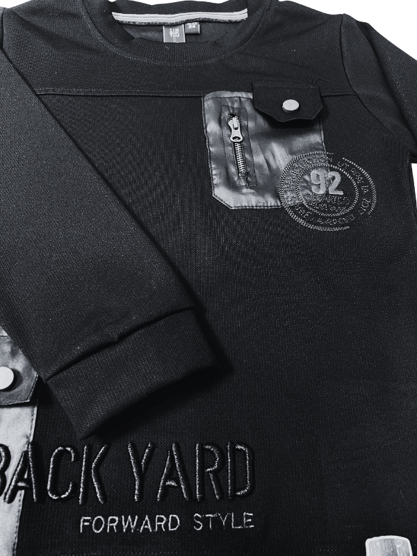 Boys' black long-sleeve sweatshirt with two contrast black utility pockets, one with a zipper, and a small orange '92' graphic on the chest.
Export to Sheets