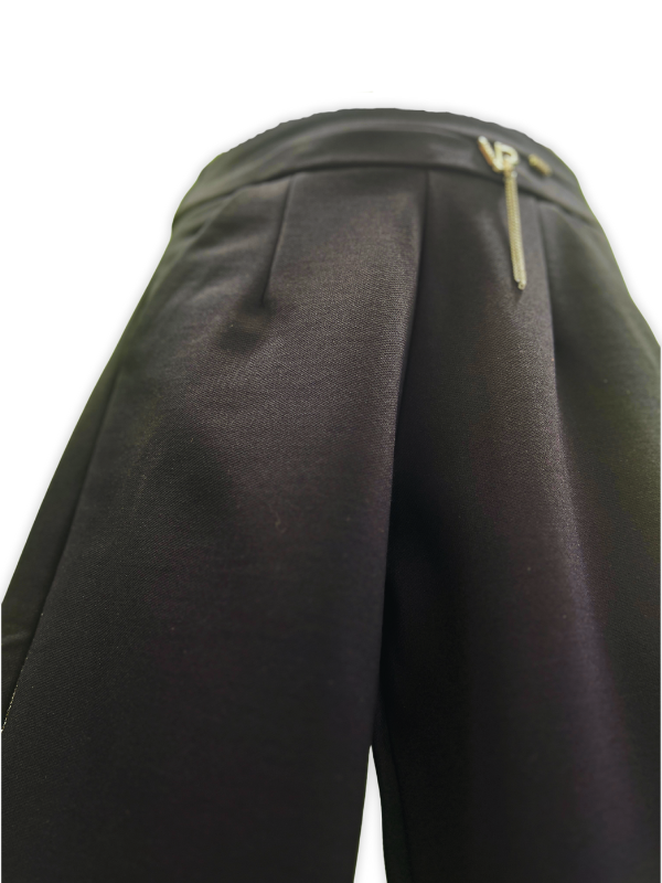 Girls' black wide-leg or palazzo-style trousers with a gold zipper accent at the waist and a delicate metallic gold glitter stripe down the outside seam of both legs.
Export to Sheets