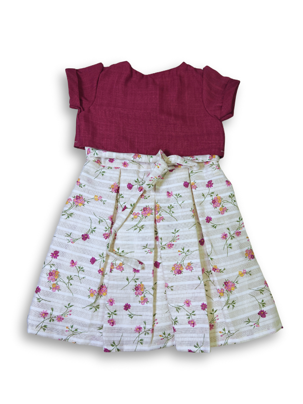 Girls' two-piece outfit featuring a berry pink textured bolero jacket with floral embroidery over a white and pink striped floral print dress with pleats.
Export to Sheets
