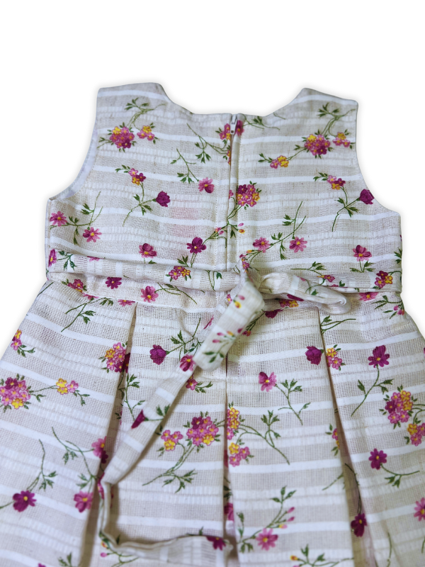 Girls' two-piece outfit featuring a berry pink textured bolero jacket with floral embroidery over a white and pink striped floral print dress with pleats.
Export to Sheets