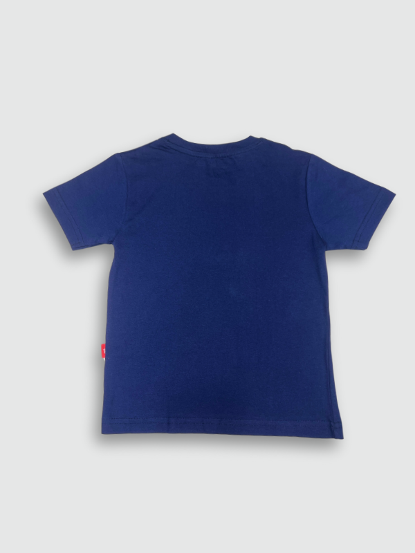 Navy blue boys' short-sleeve T-shirt with a layered-look hem, featuring the white cursive text "Free Spirit" and a small cartoon illustration of a traveler with a backpack