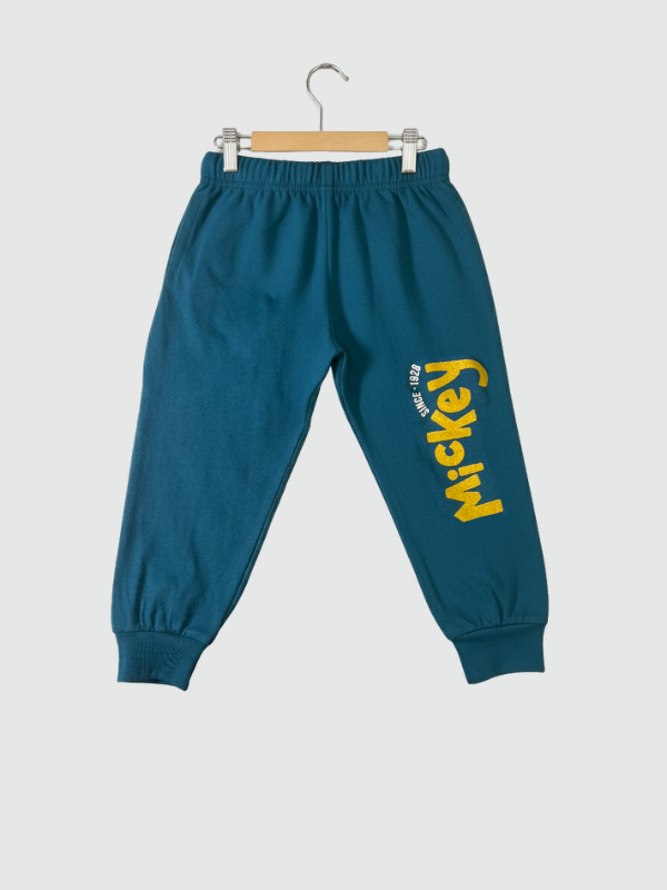 Two-piece boys' long-sleeve night suit in deep teal blue, featuring a large yellow "Mickey" graphic of the Disney character on the top and a matching logo print on the jogger pants