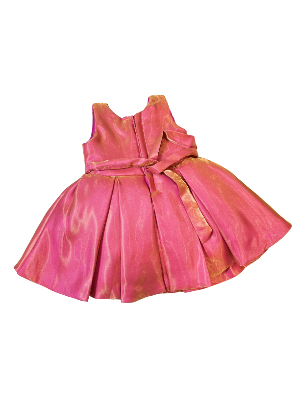 Bright orange girls' frock with full sleeves on a hanger, covered in a multicolored abstract print with gold trim and white tassel/pearl embellishments near the waist.