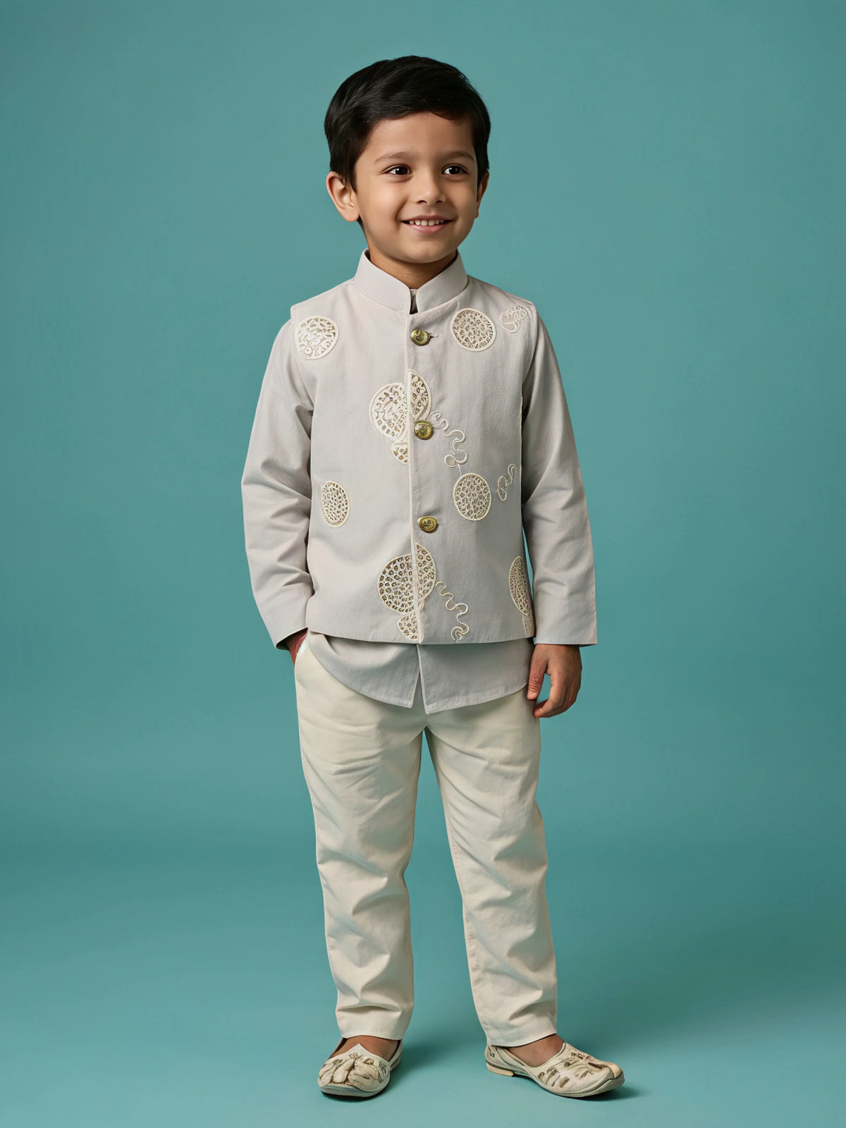 Boys cream kurta pajama set with a matching mirror work jacket.