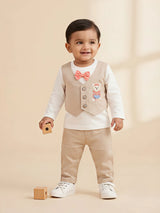 Boys cream clothing set featuring a sleeveless waistcoat with a teddy bear embroidery, long sleeve top with a bow tie, and cream trousers.
