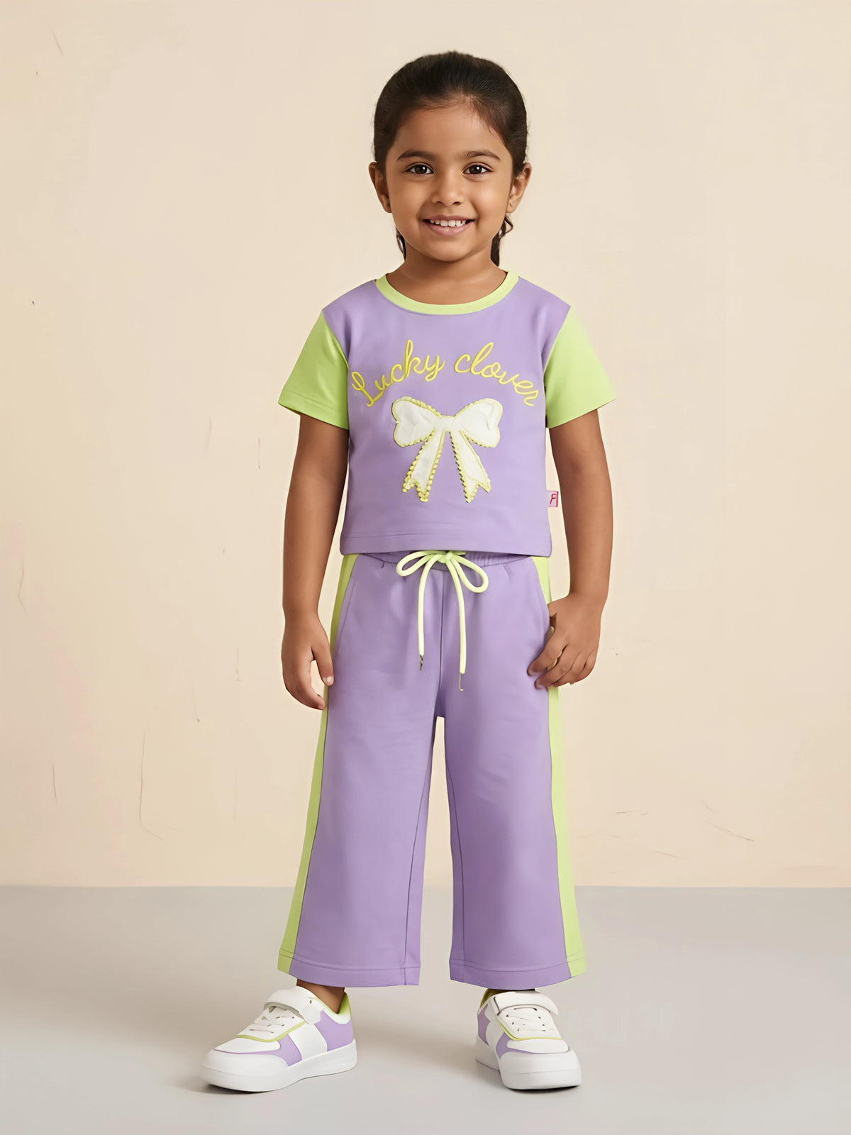 Purple Lucky Clover graphic t-shirt and shorts coordinate set for girls laid flat on a white background.