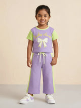 Purple Lucky Clover graphic t-shirt and shorts coordinate set for girls laid flat on a white background.