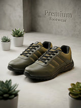 A pair of premium olive green lace-up sneakers with black accents and a rugged sole, featuring a stylized S logo on the tongue.