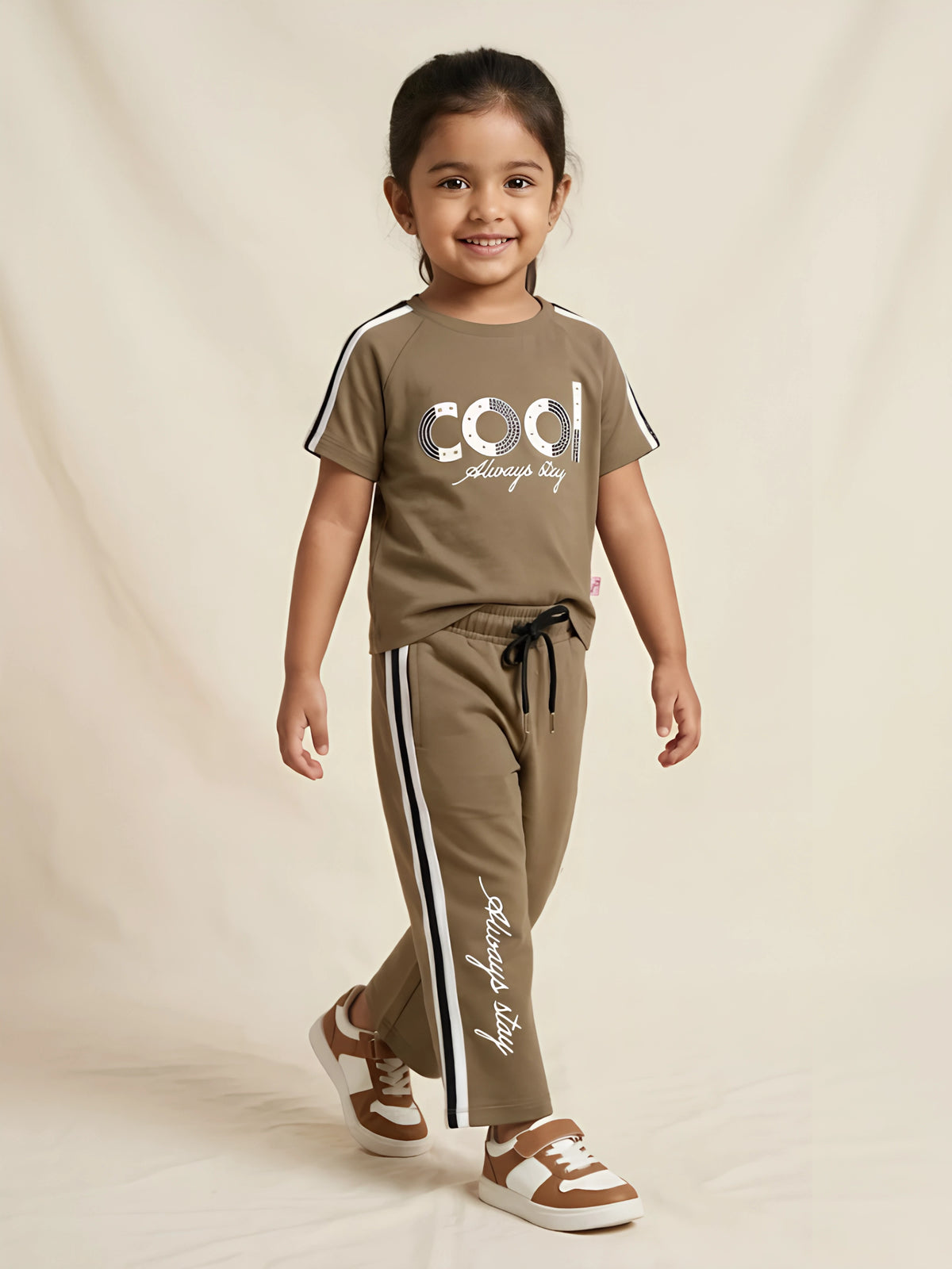 Brown graphic print girls coordinate set featuring a t-shirt and track pants with white side stripes.