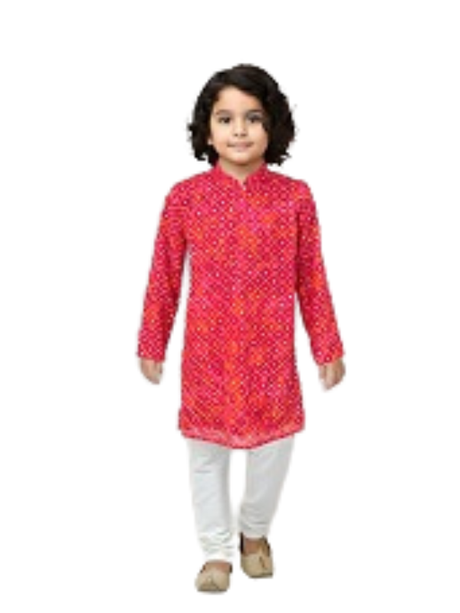 Young boy with curly hair wearing a long-sleeve bright red and pink Bandhani print kurta with a Mandarin collar, paired with solid white pyjama bottoms and traditional Indian shoes