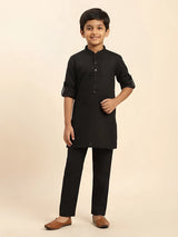 Folded black boys kurta pajama set with designer embroidered placket and matching pants.