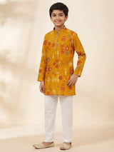 Yellow ikat print kurta pajama set for boys with white pajama pants.