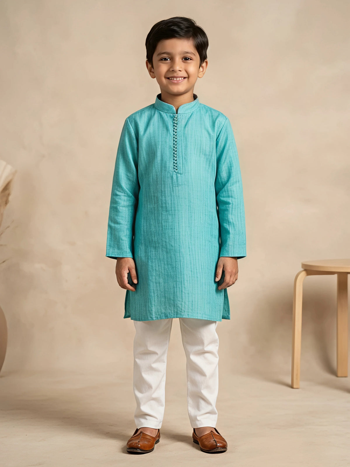 Young boy wearing a sea green textured mandarin collar kurta paired with white trousers