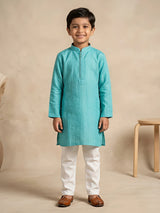 Young boy wearing a sea green textured mandarin collar kurta paired with white trousers