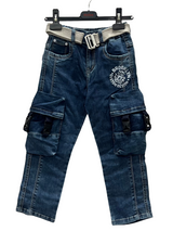 A pair of boys' dark wash denim cargo jeans hanging on a hanger, featuring large buckle-closure pockets on the legs, a white 'Brooklyn' graphic, and a light gray canvas belt.