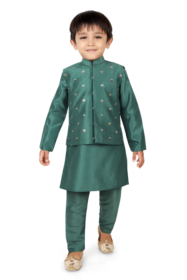 Young boy wearing a monochromatic peacock green kurta pajama set, layered with a matching long-sleeved jacket featuring small gold embroidery, and festive gold ethnic shoes.