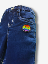 Boys' dark indigo blue denim jeans with a wide knit fabric waistband, silver belt buckle, and a hanging logo charm.

Export to Sheets