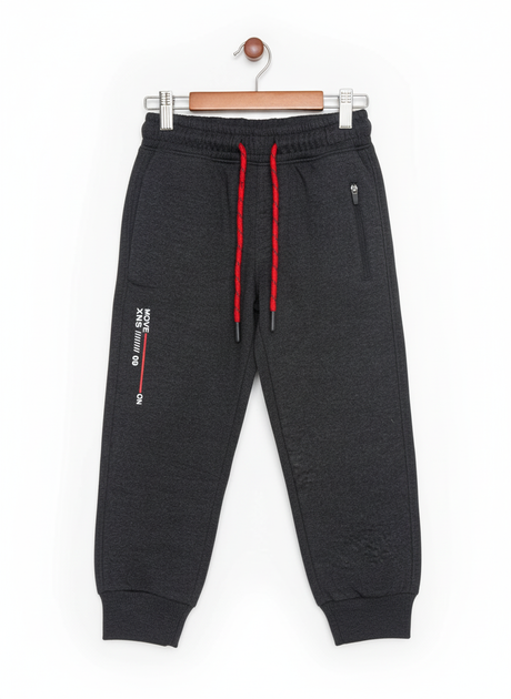 A pair of boys' dark grey fleece jogger track pants with an elastic waist, red and black contrast drawstring, ribbed ankle cuffs, and a vertical zippered pocket.