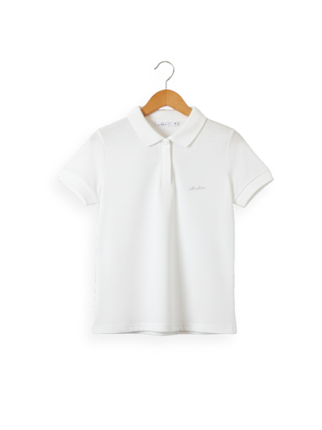 Front view of a girls' plain white short-sleeve polo shirt with a collar, two-button placket, and a small embroidered logo on the chest, hanging on a wooden hanger.