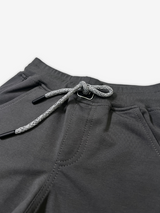Boys' dark charcoal grey jogger pants with an elastic waist, cuffed ankles, and a visible speckled grey and white rope drawcord.

Export to Sheets