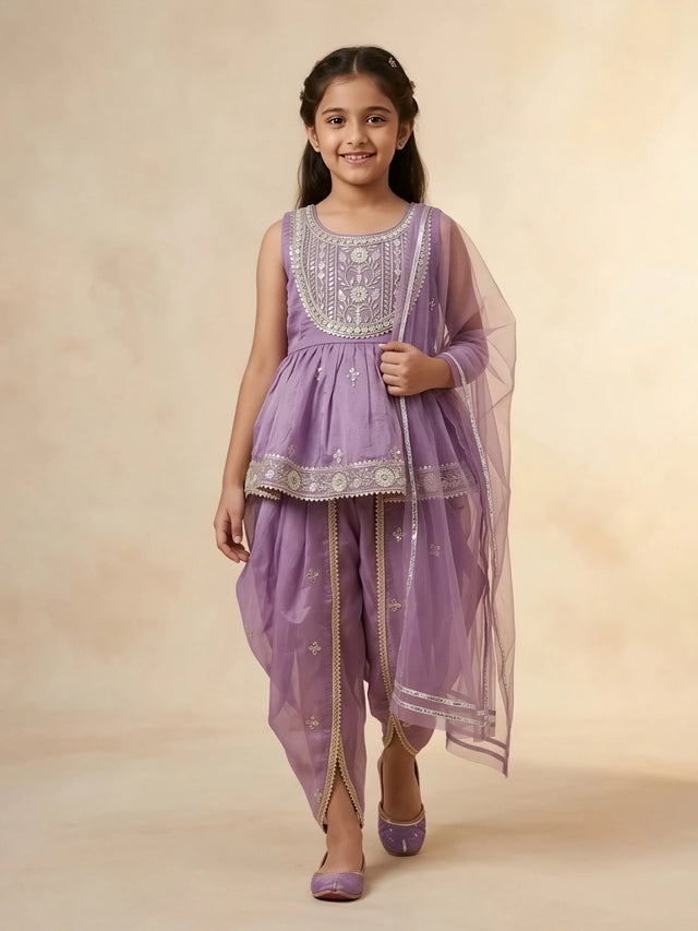 Girls purple ethnic set featuring a sleeveless embroidered short kurti, draped dhoti pants with gold lace trim, and a sheer net dupatta