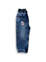 Boys' medium blue wash jogger pants with an elastic waist, white drawstring, embroidered patch on the left thigh, and cuffed ankles.

Export to Sheets
