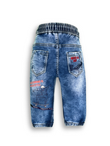 Boys' medium blue wash jogger pants with an elastic waist, white drawstring, embroidered patch on the left thigh, and cuffed ankles.

Export to Sheets