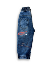 Boys' medium blue wash jogger pants with an elastic waist, white drawstring, embroidered patch on the left thigh, and cuffed ankles.

Export to Sheets