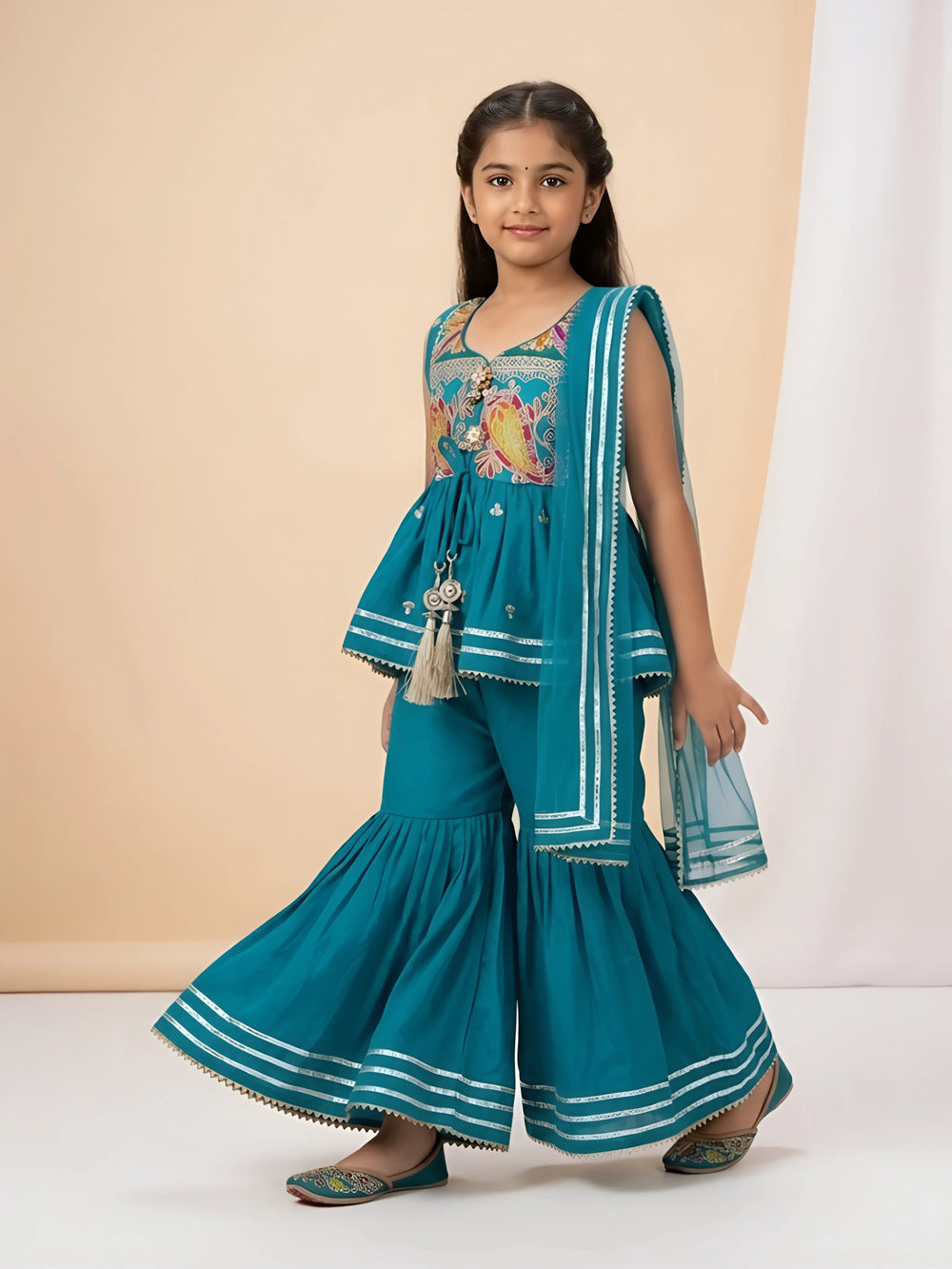 Shop this stylish green ethnic sharara set for girls featuring a printed peplum short kurta, flared sharara bottoms, and matching lace dupatta.