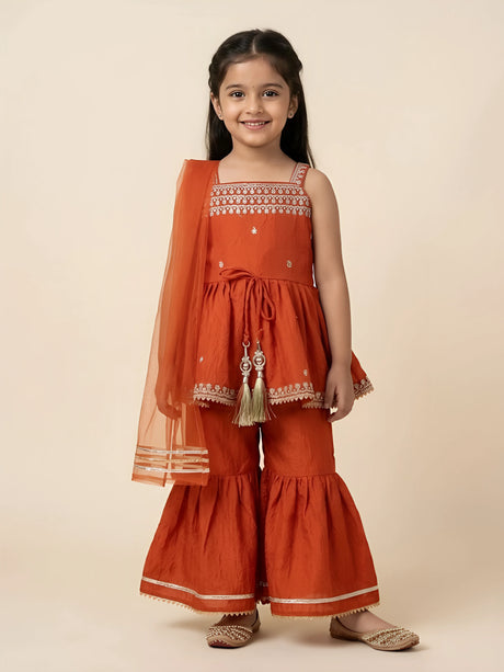 Orange embroidered palazzo set for girls with matching dupatta displayed flat.