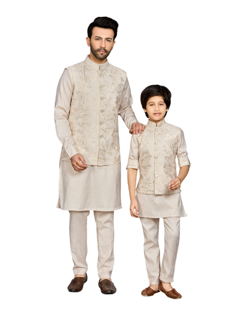 Young boy modeling a full-sleeve cream kurta set layered with a long, sleeveless jacket featuring dense tonal and gold-toned embroidery.