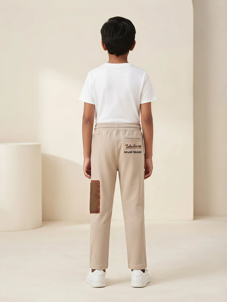 Boys Cream Stylish Cargo Track Pants with Drawstring & Pocket Detail.