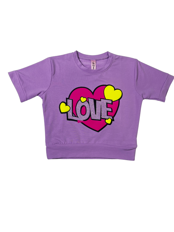 Girls' short-sleeve lavender/purple top with a large central graphic featuring a pink heart, the word 'LOVE' in white sequins, and small yellow hearts.

Export to Sheets