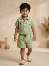 Green geometric printed shirt and shorts boys coordinate set displayed flat on a white background.