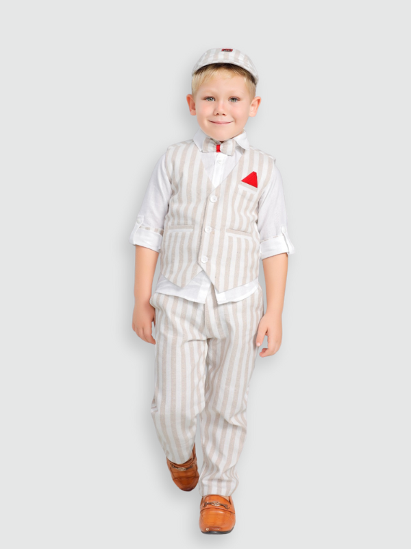 Full-body shot of a young boy wearing a vintage-style suit set, including a cream/beige striped waistcoat, matching trousers, a white shirt, a red bow tie/pocket square, and a striped flat cap.