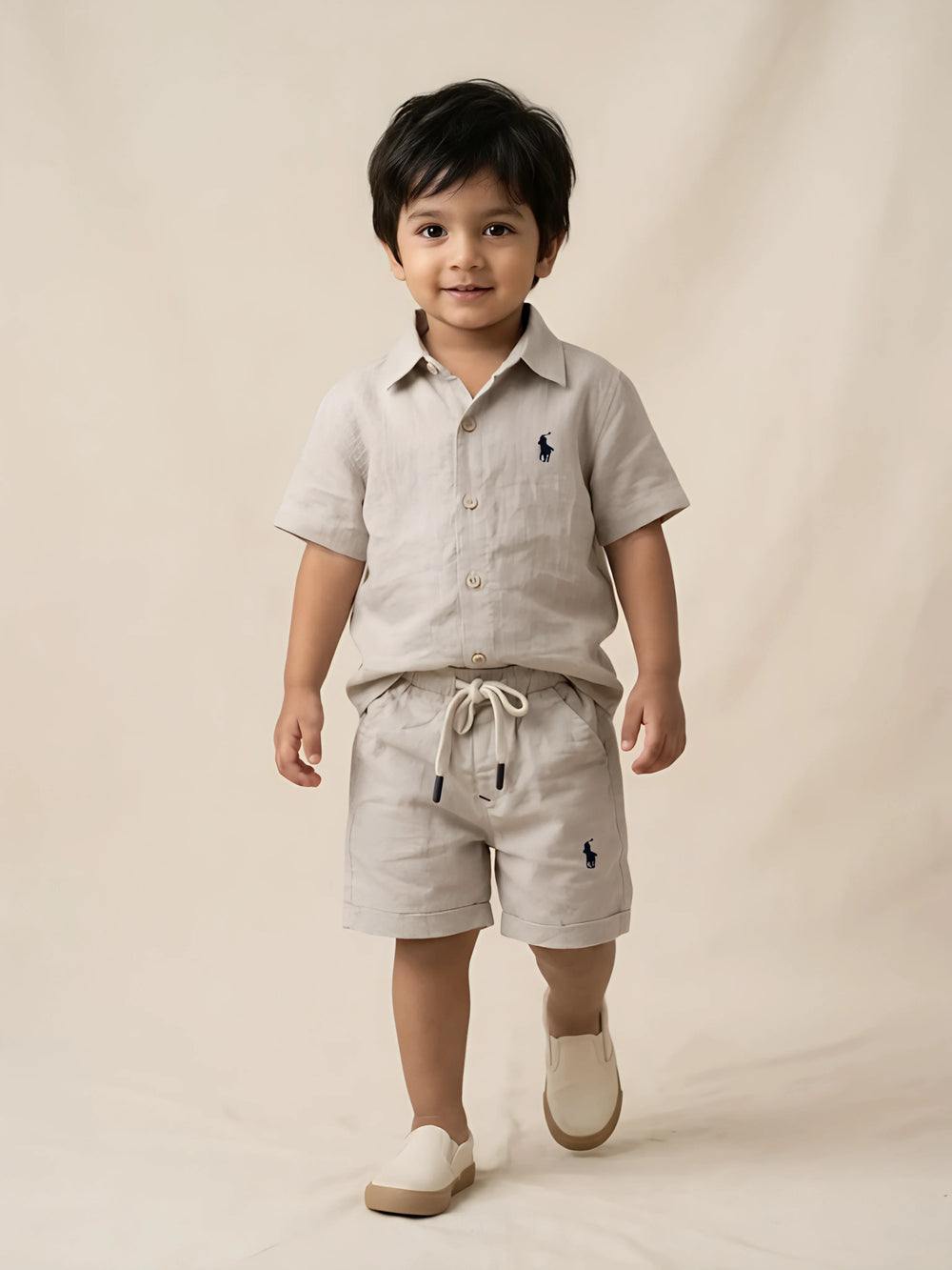 Cream casual cotton boys coordinate set laid flat against a white background.